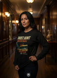 Woman wearing a black long-sleeve shirt with 'Ghost Hunt Weekends' text in a dimly lit hallway.